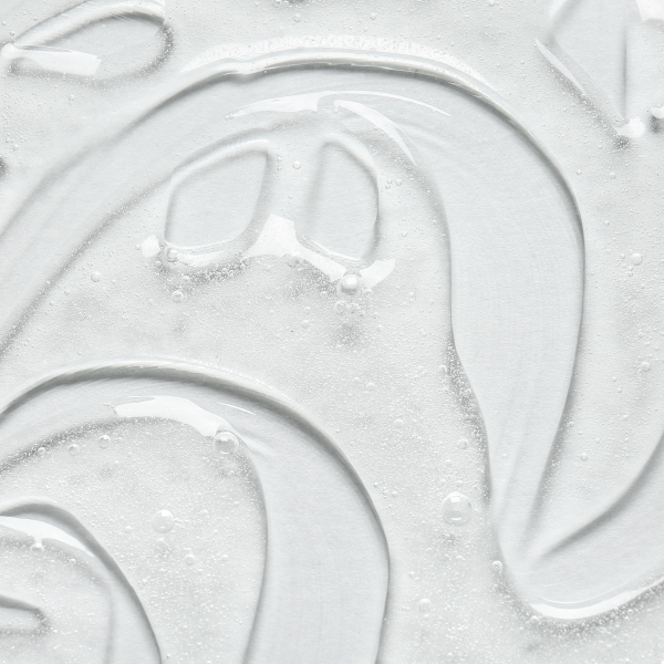 Clear gel with a smooth, glossy texture and small bubbles, arranged in a visually appealing pattern with a swirling design.